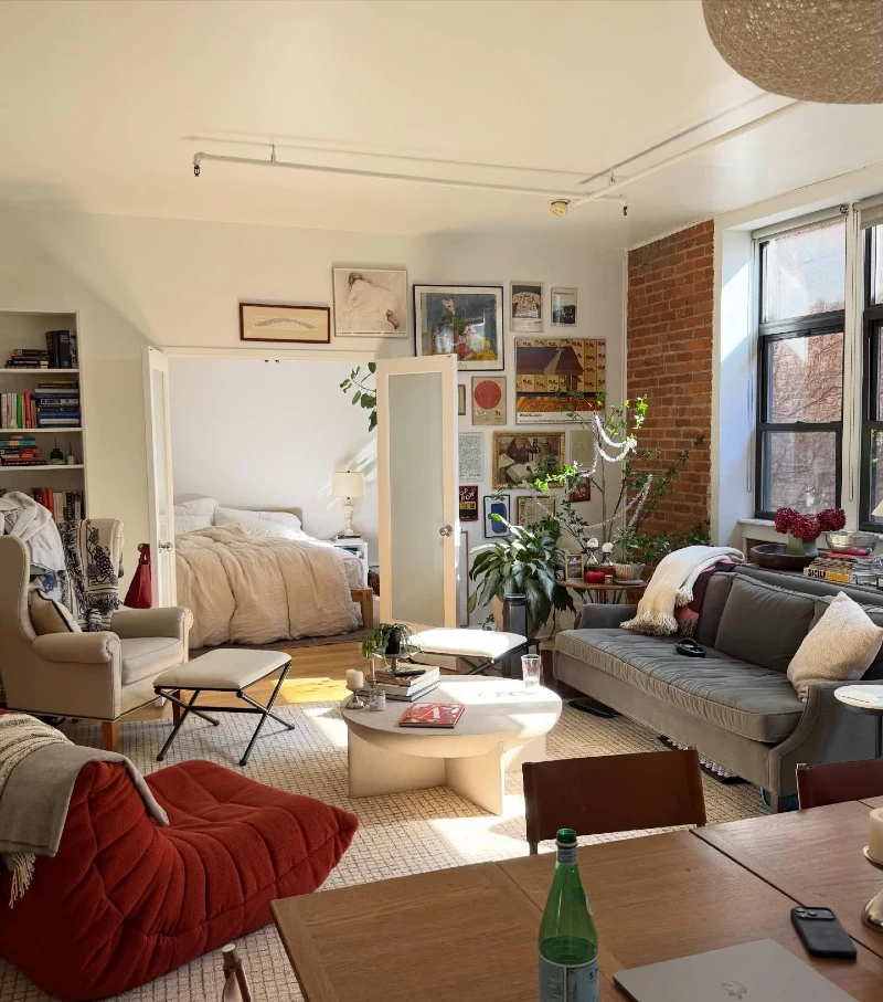 Brick Accent Living Room with Organic Gallery Wall Flow