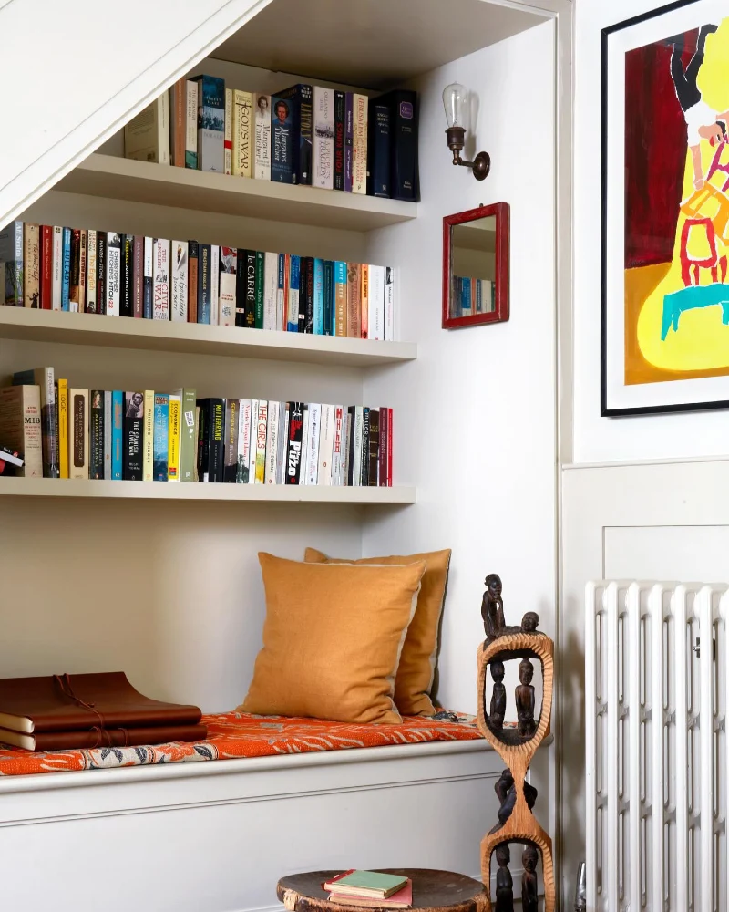 Built-In Library Bench with Orange Patterned Cushion and Mustard Pillows
