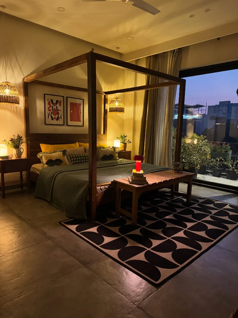 Canopy Frame Bedroom with Warm Pendant Lighting and Balcony Night View
