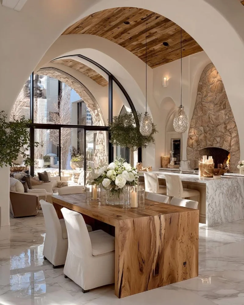 Chunky Live-Edge Dining Table with Barrel-Vaulted Wood Ceiling and Stone Fireplace Arch