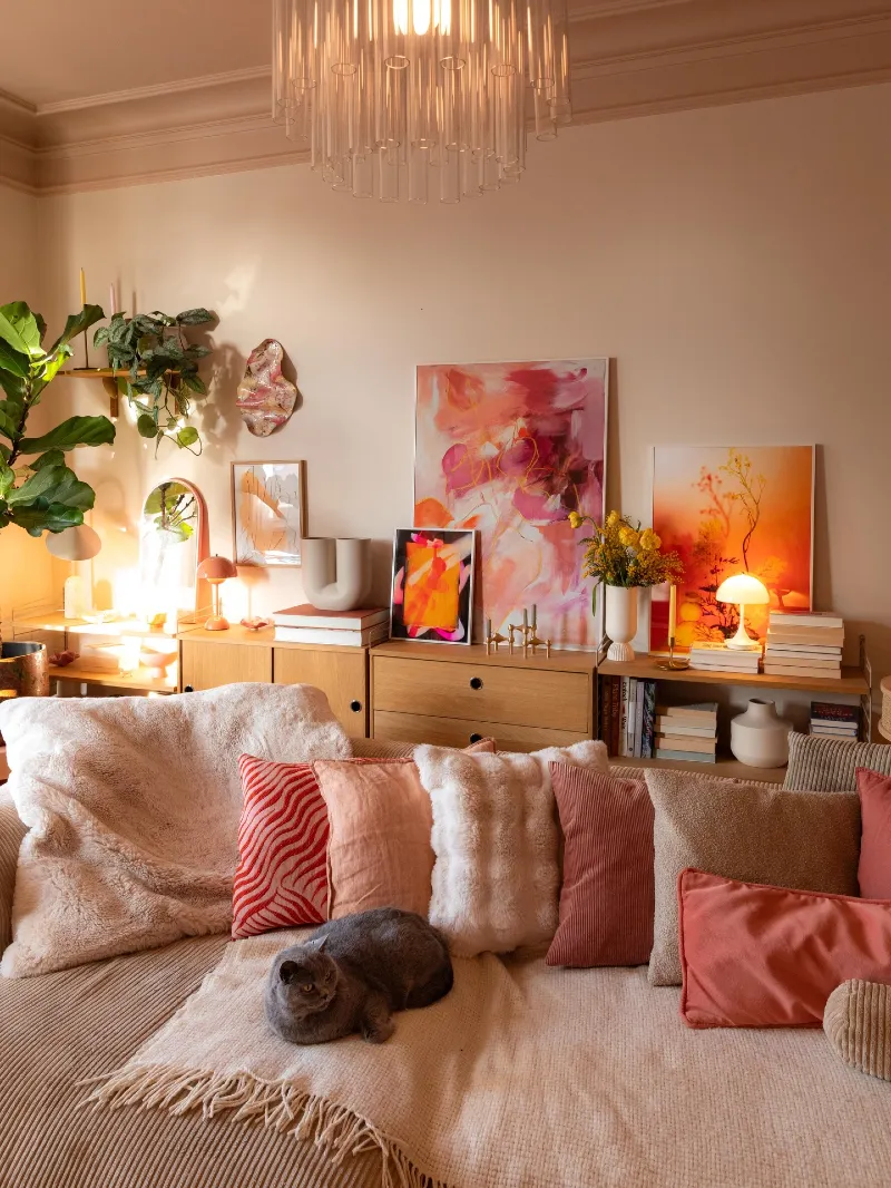 Coral Layered Sofa Living Room with Abstract Gallery Wall and Warm Ambient Glow