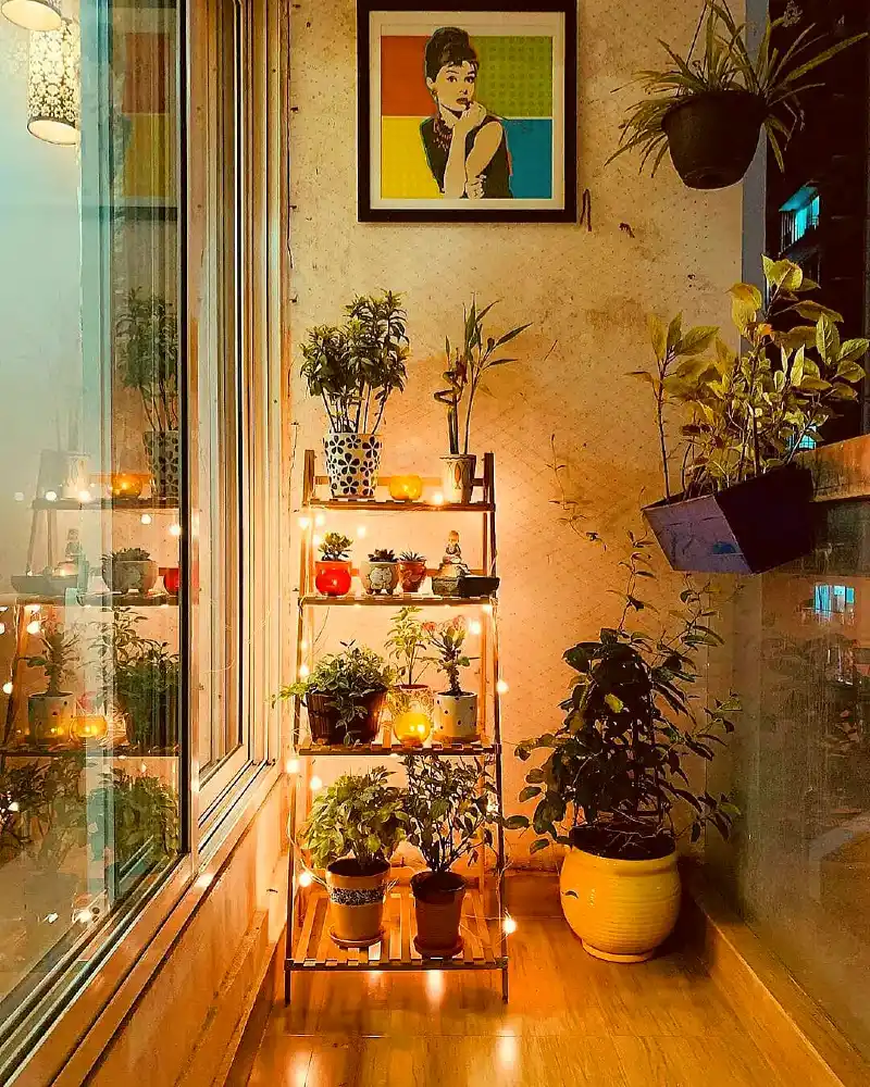 Cozy Apartment Balcony with Multi-Tiered Ladder Rack and Fairy Lights