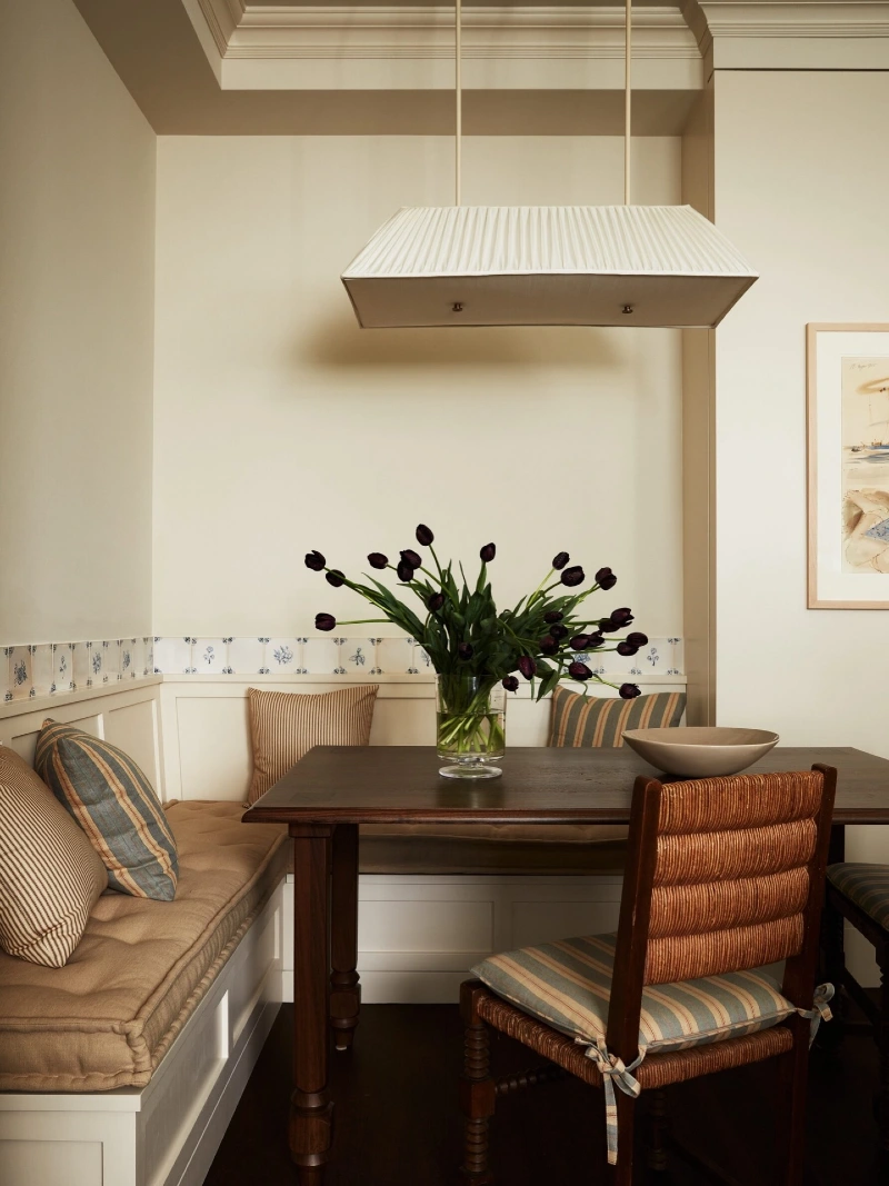 Cream Corner Banquette with Pleated Pendant and Striped Cushions