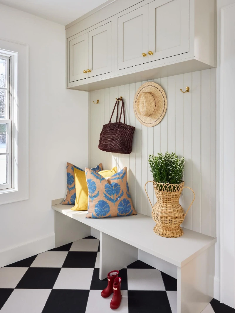 Cream Mudroom Bench with Blue Floral Pillows and Checkerboard Floor