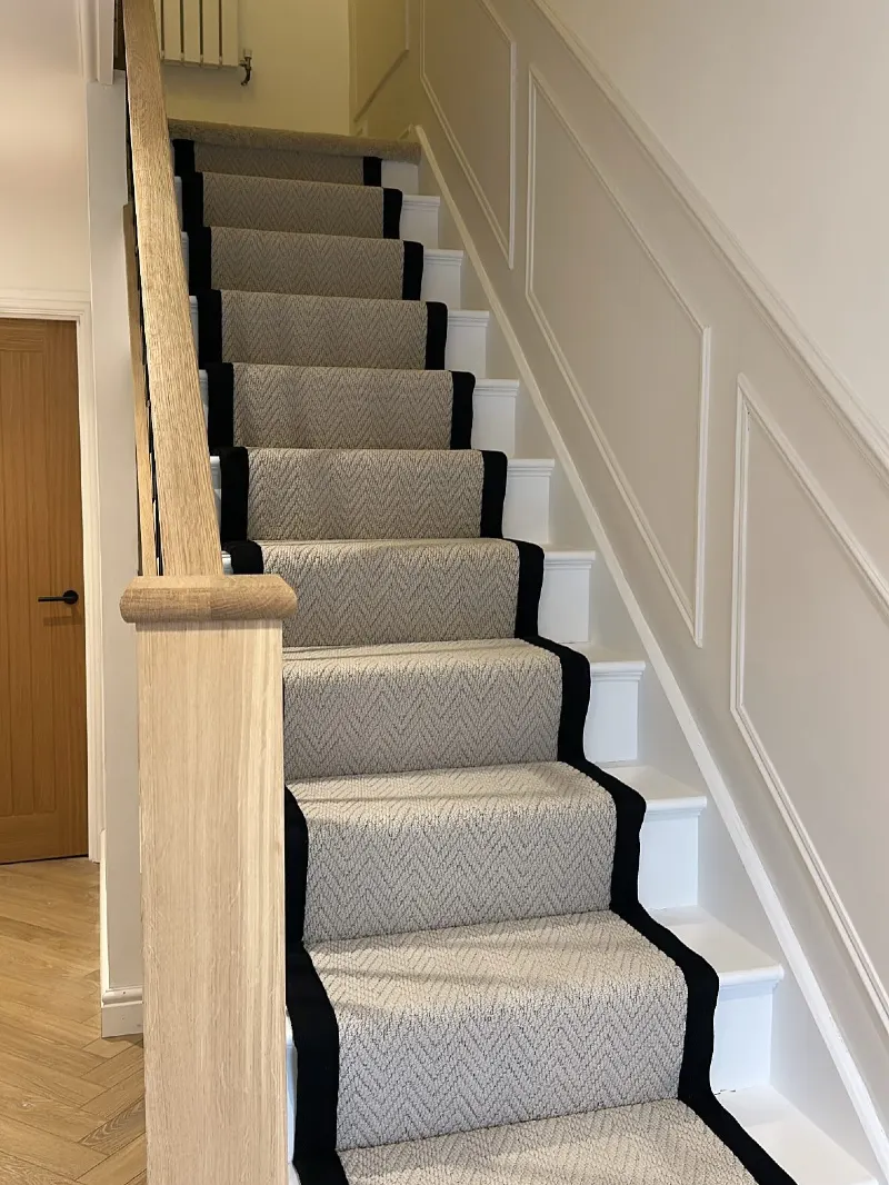 Cream Picture Frame Molding with a Chevron Carpet Runner and Oak Newel Post