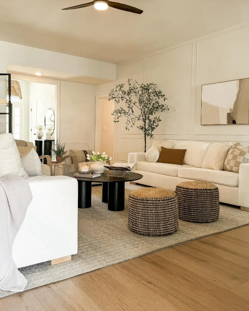Cream Sofas with Black Round Coffee Table and Woven Poufs