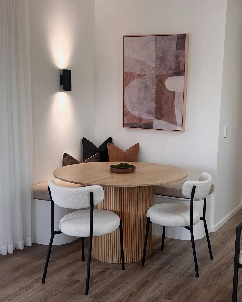 Curved Banquette with Fluted Wood Table and BouclΓ© Chairs