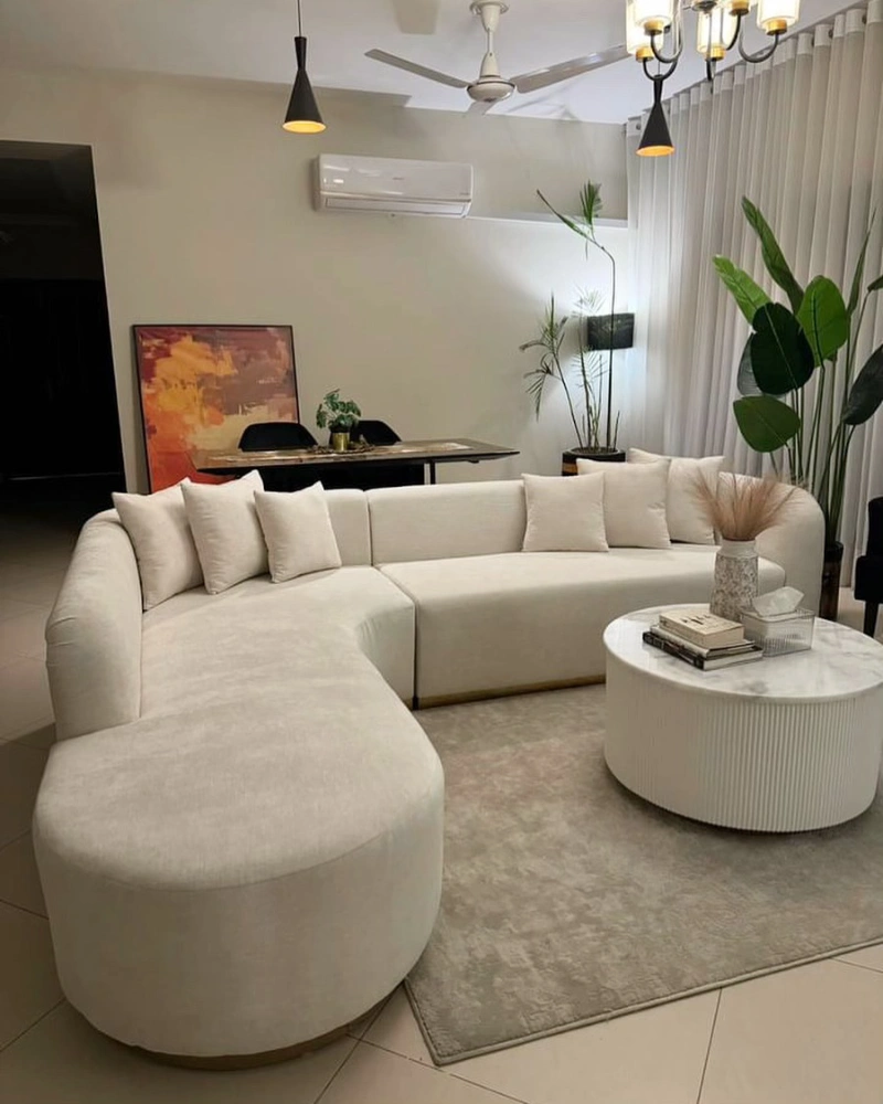 Curved Sectional Beige Lounge with Dark Accent Wall Contrast