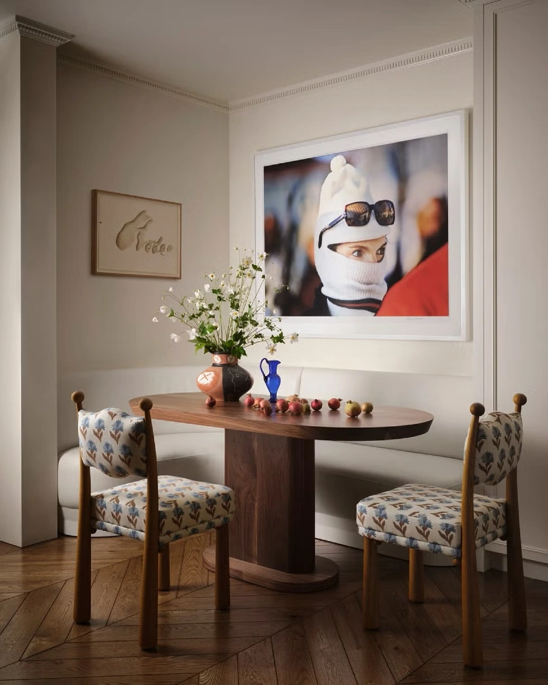 Curved Wood Table with Floral Chairs and Gallery Wall Drama