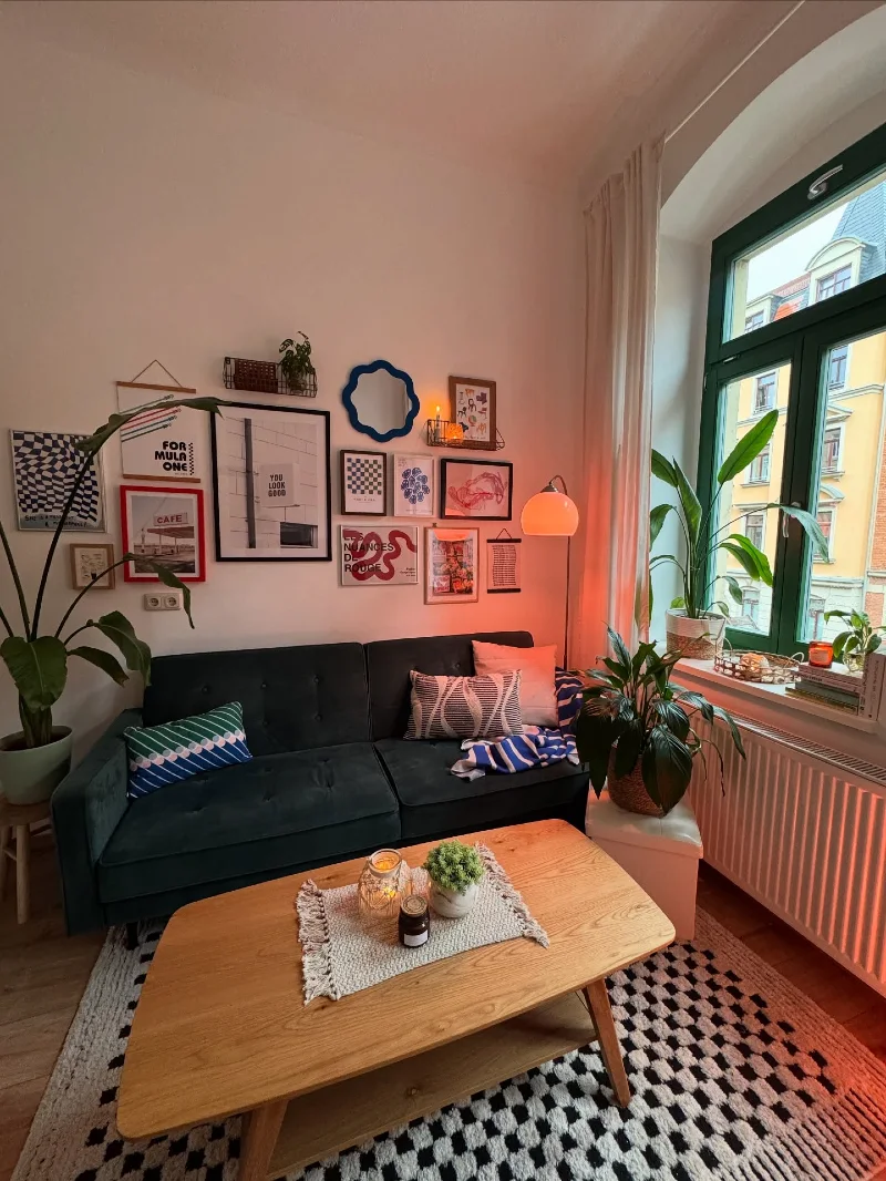 Dark Green Sofa Gallery Wall with Warm Orange Corner Glow