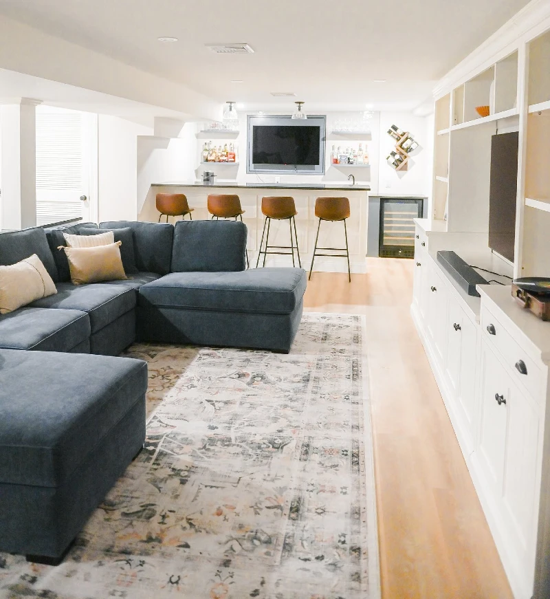 Deep Blue Sectional Sofa with White Built-in Media Center and Warm Leather Barstools