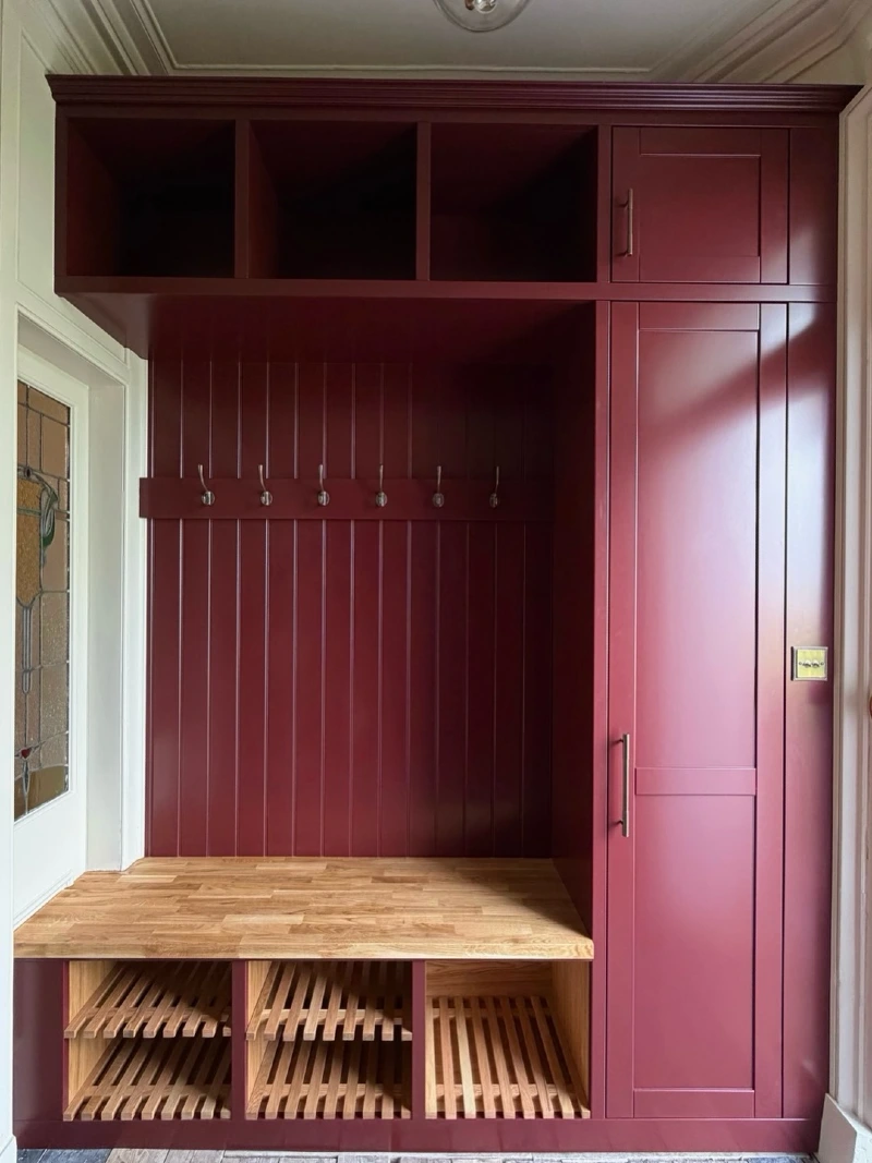 Deep Burgundy Entryway Cabinetry with Slatted Wooden Shoe Grates and Butcher Block Bench