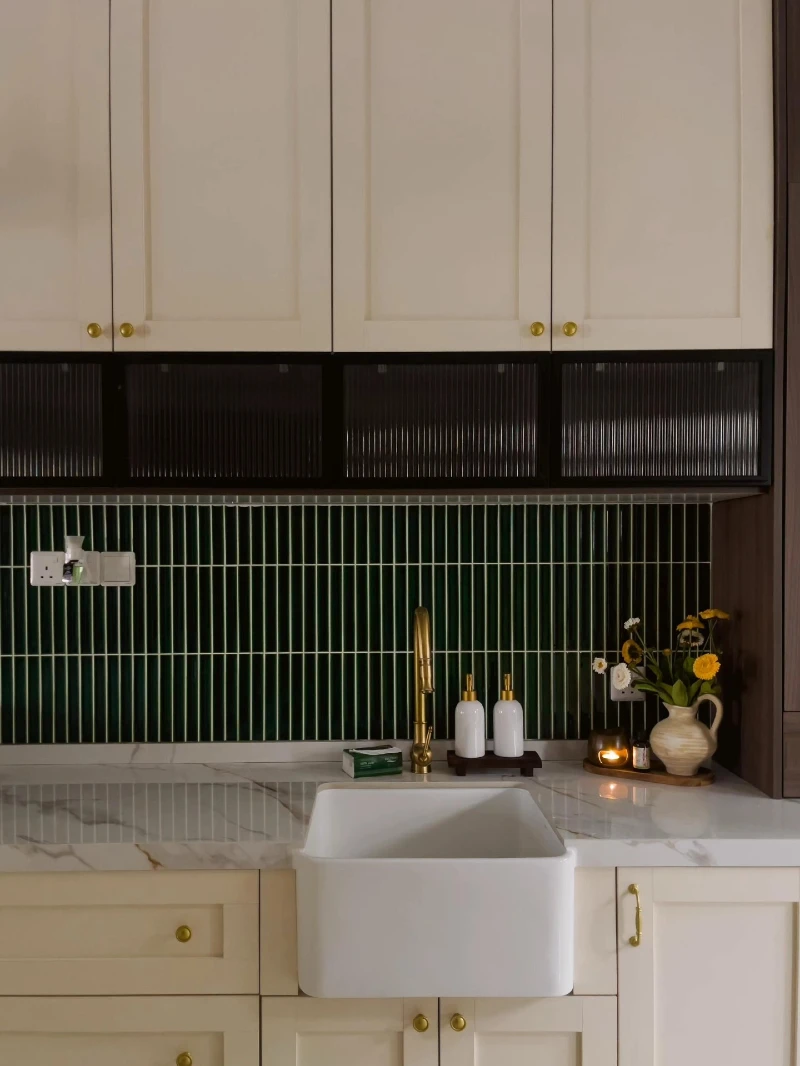Deep Green Vertical Tile Backsplash Behind Cream Cabinet Sink Station