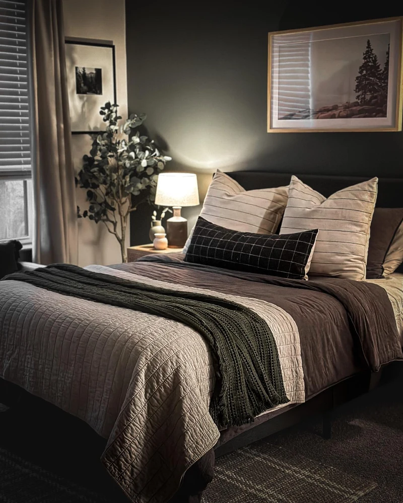 Deep Olive Accent Wall with Layered Neutrals and Warm Bedside Glow