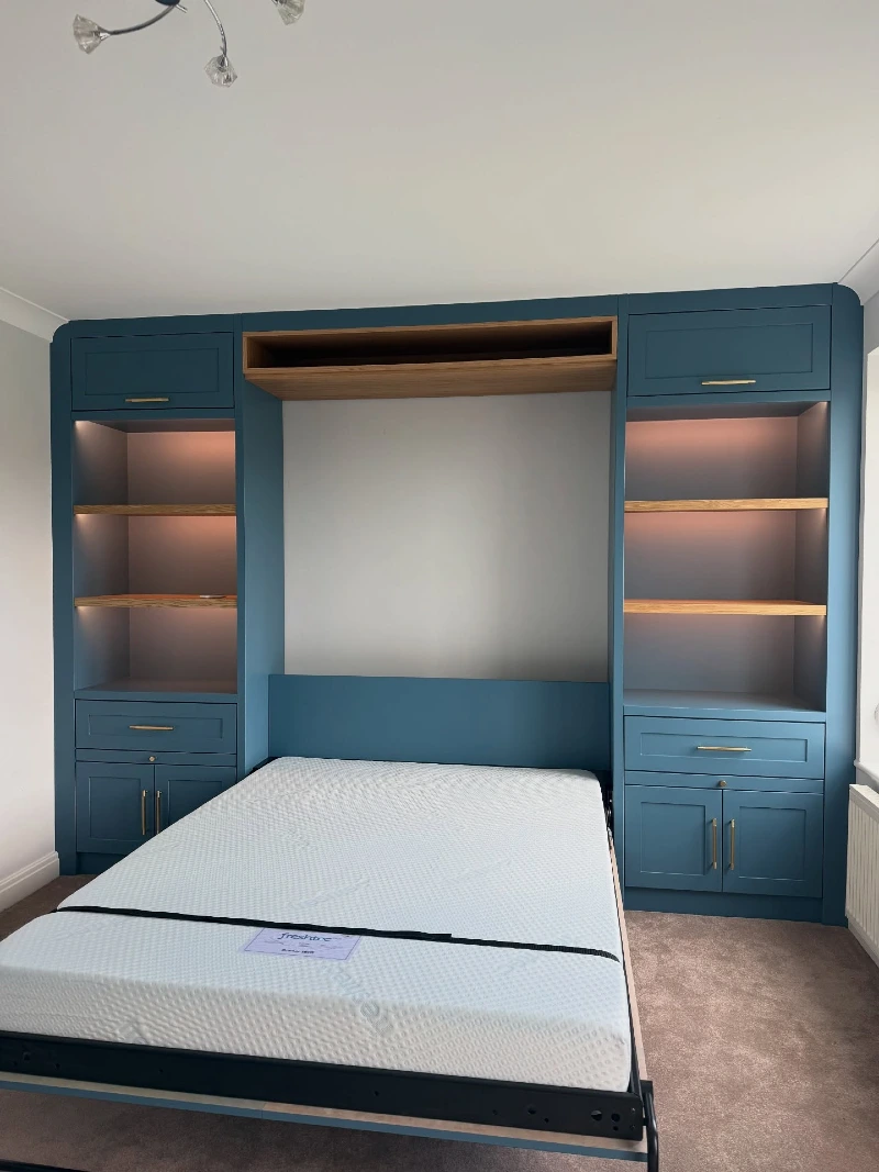 Deep Teal Shaker Units with Backlit Wooden Shelves and Minimalist White Mattress