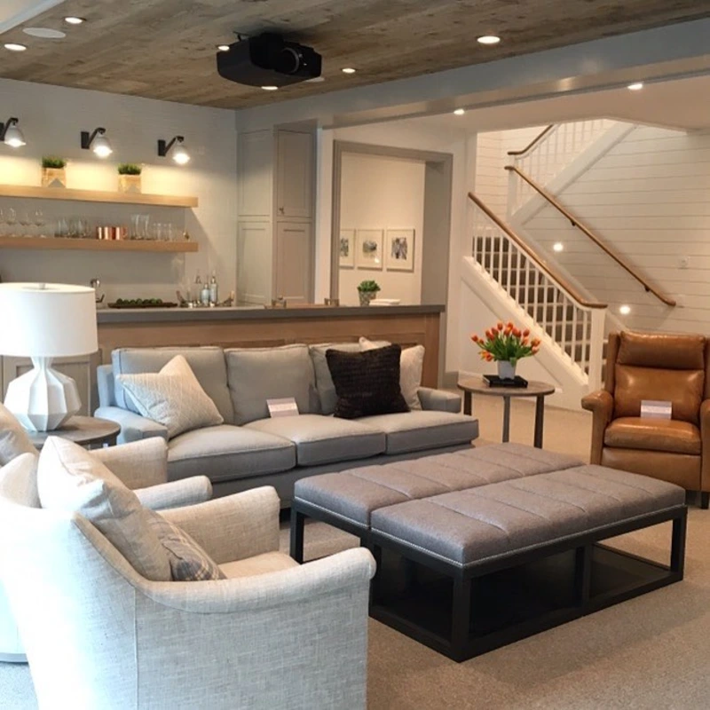 Distressed Wood Ceiling Planks with Tufted Gray Ottoman Coffee Table and Camel Leather Recliner