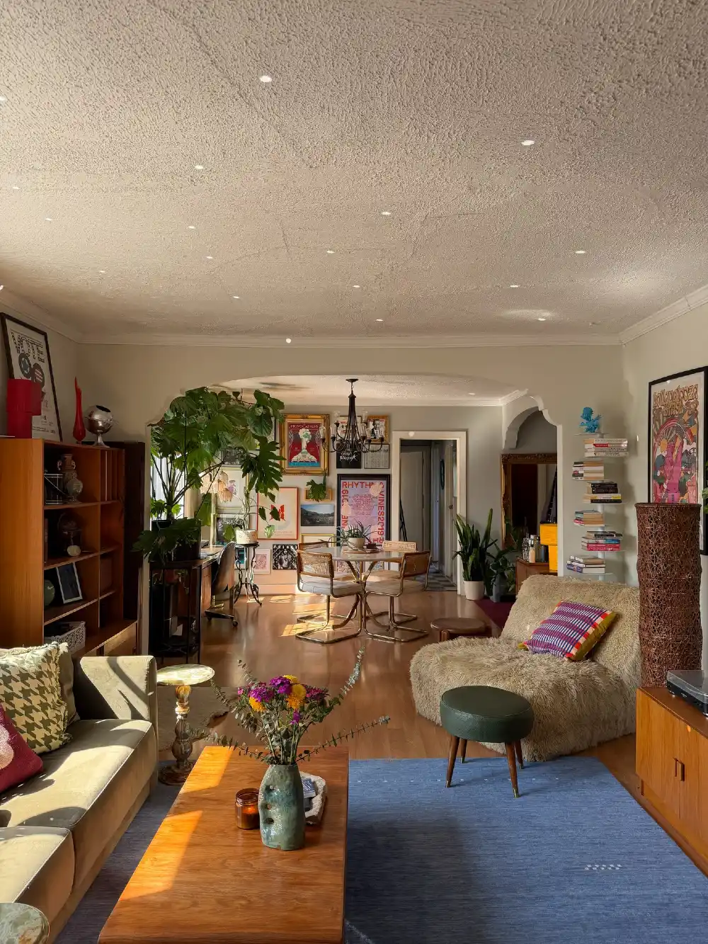 Eclectic Open Plan Living Room with Blue Rug, Gallery Walls and Mixed Seating