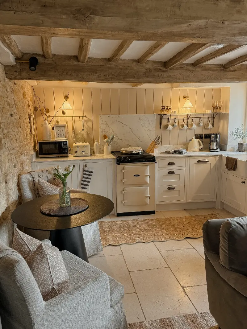 Exposed Beam Kitchen with Cream Aga and Stone Wall