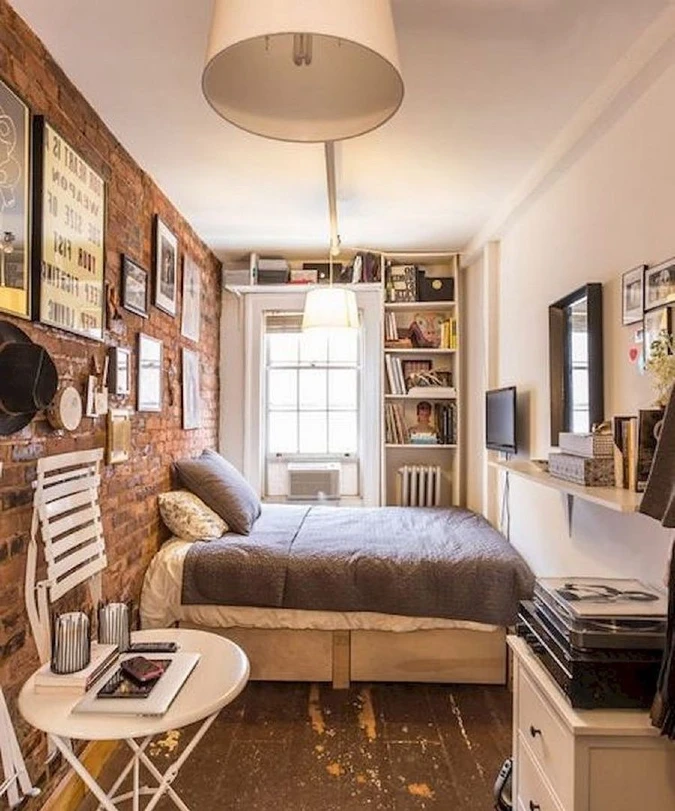 Exposed Brick Bedroom with Built In Shelves and Floating Media Ledge