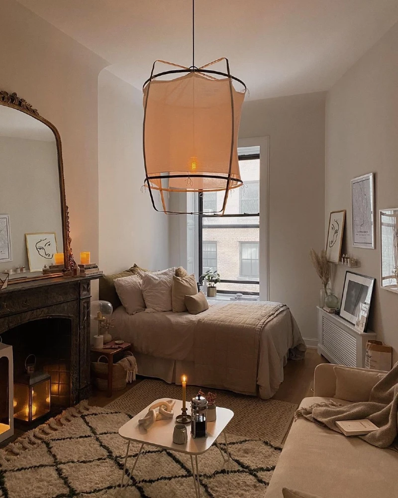 Fireplace Lounge Bedroom with Oversized Lantern Pendant and Soft Neutral Layers