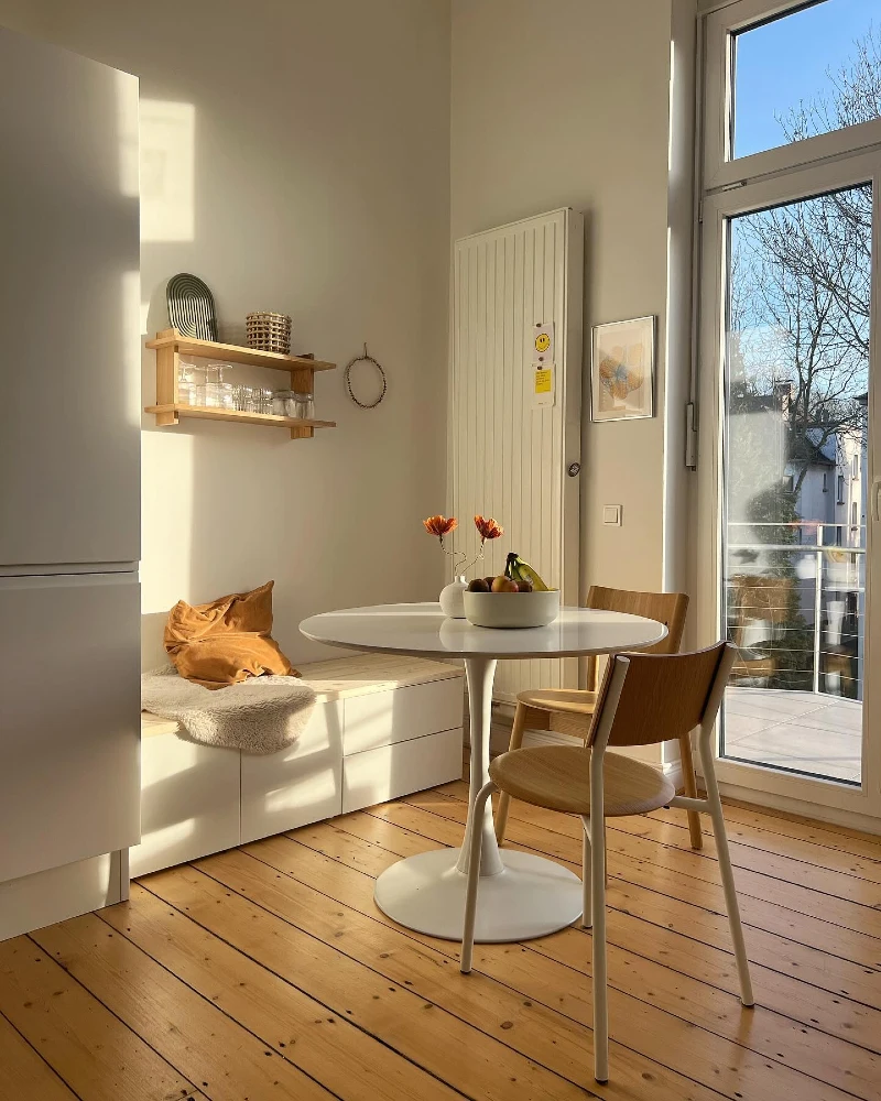 Floating Window Bench with White Table and Warm Wood Chairs