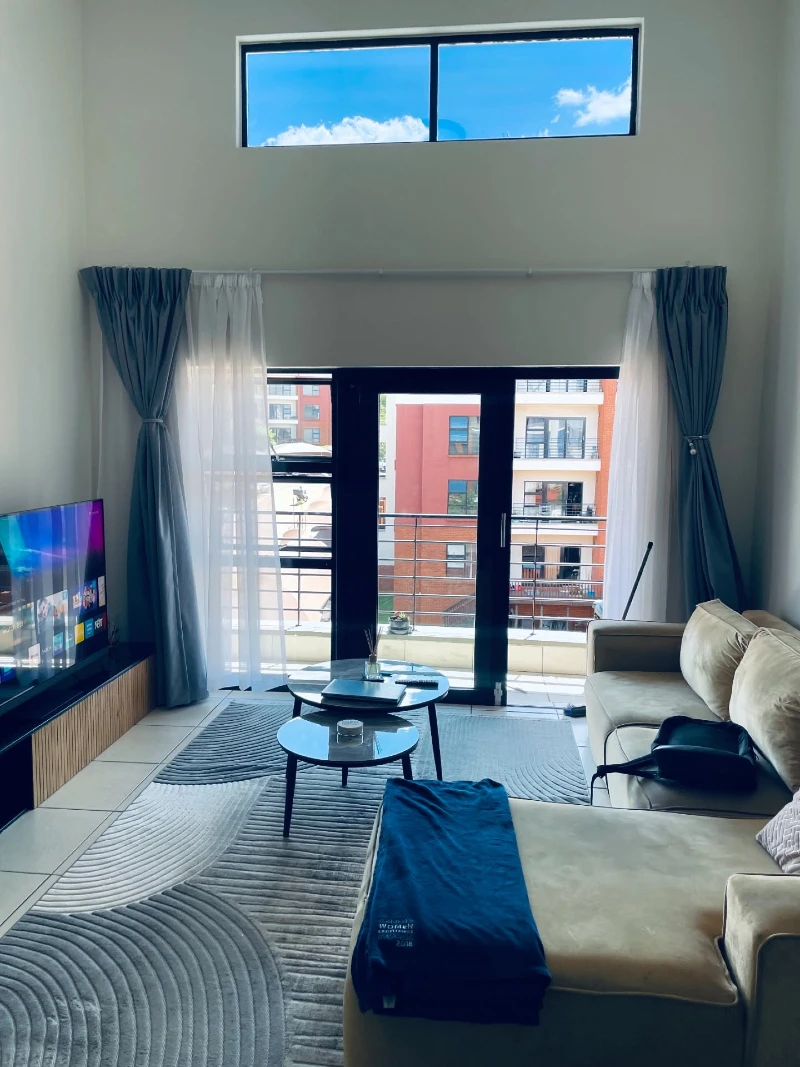 Floor-to-Ceiling Glass Doors with Light-Drenched Living Zone