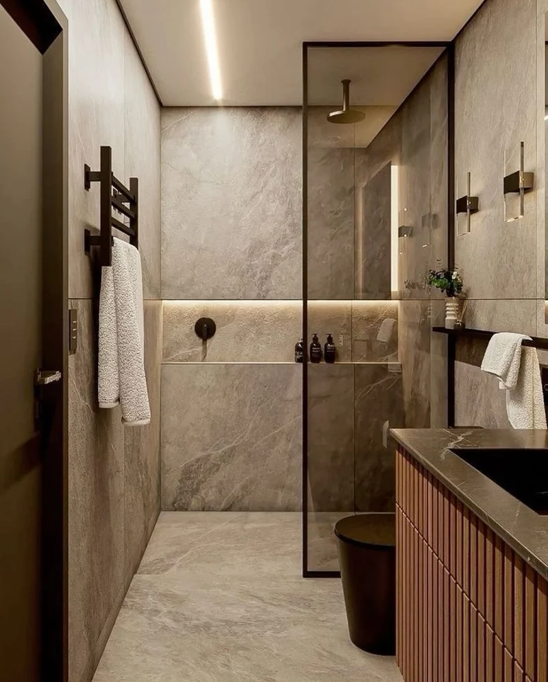 Fluted Wood Vanity with Large-Format Grey Stone Tiles and Illuminated Shower Niche