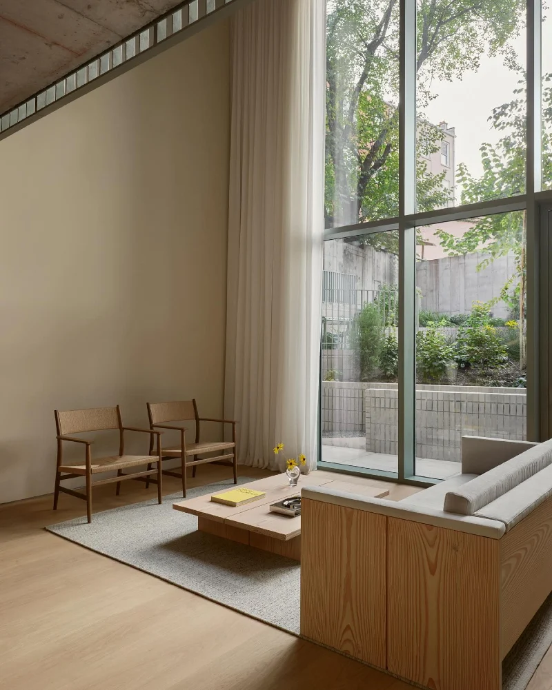 Full-Height Window Studio with Light Curtains and Warm Neutral Living Flow