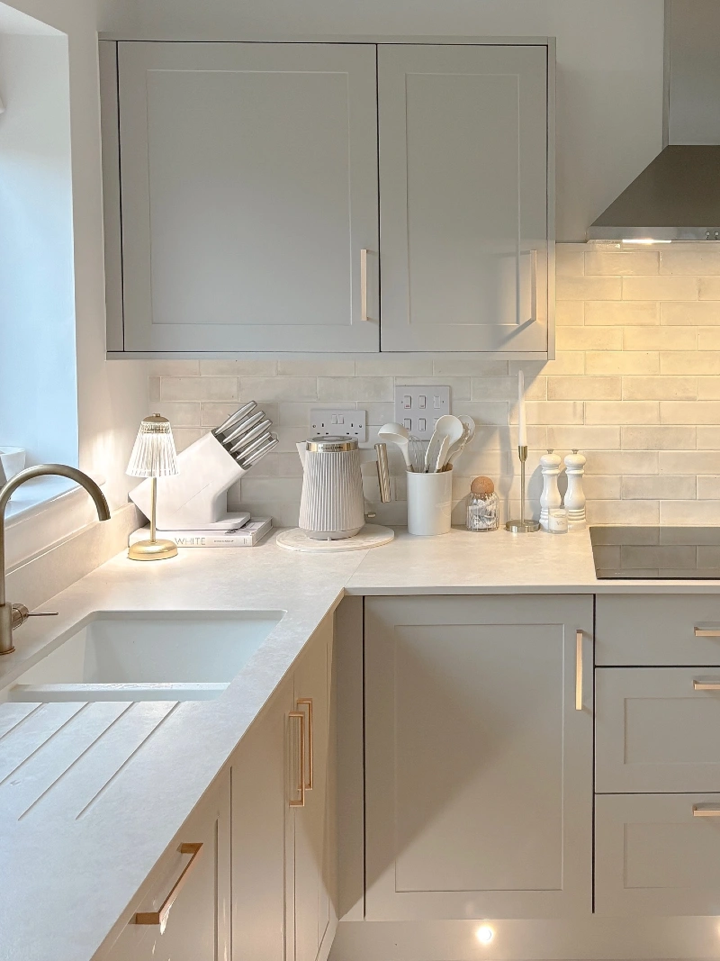 Glass Lamp Counter Corner with White Knife Block, Ribbed Kettle, and Brass Pulls