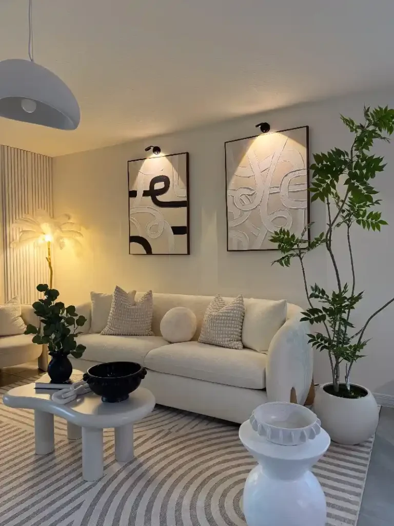 Graphic Abstract Art with Curved Cream Sofa and Picture Lights