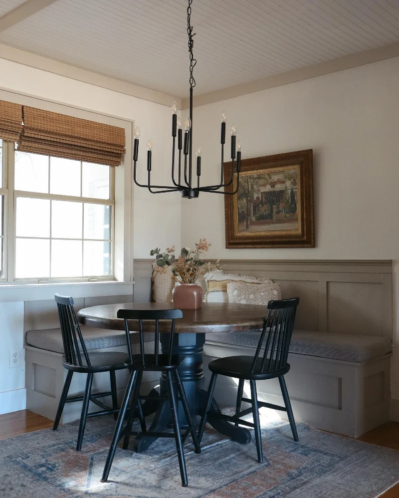 Gray Corner Banquette with Black Spindle Chairs and Farmhouse Chandelier