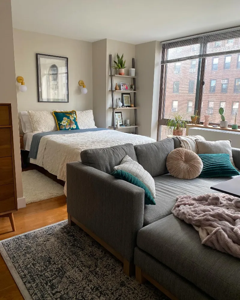 Grey Sofa Bedroom Studio with Window Light and Built In Storage Corner