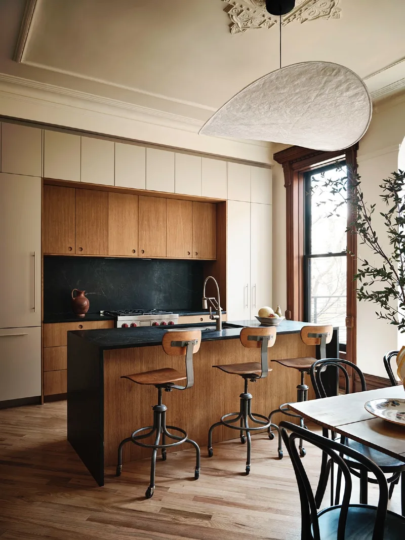 Inset Oak Cabinets Matched With Soapstone Countertops and Industrial Draftsman Stools