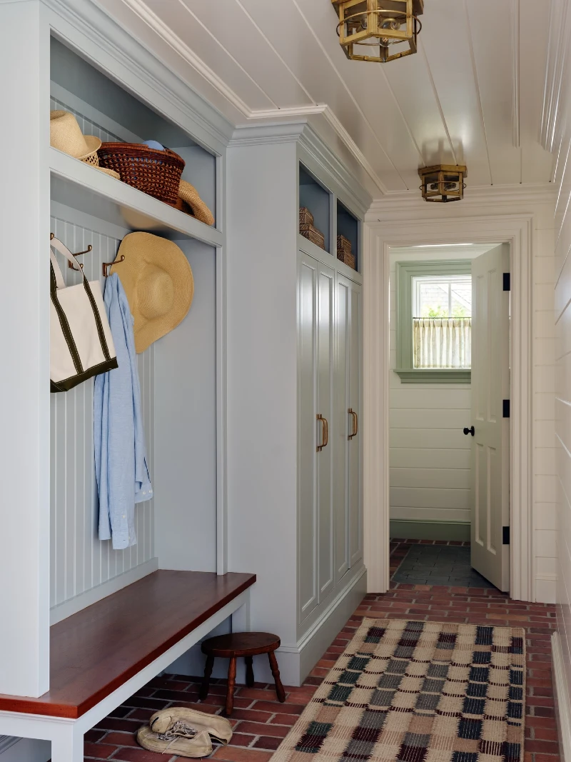 Light Blue Mudroom Hallway with Mahogany Bench and Brick Paver Flooring