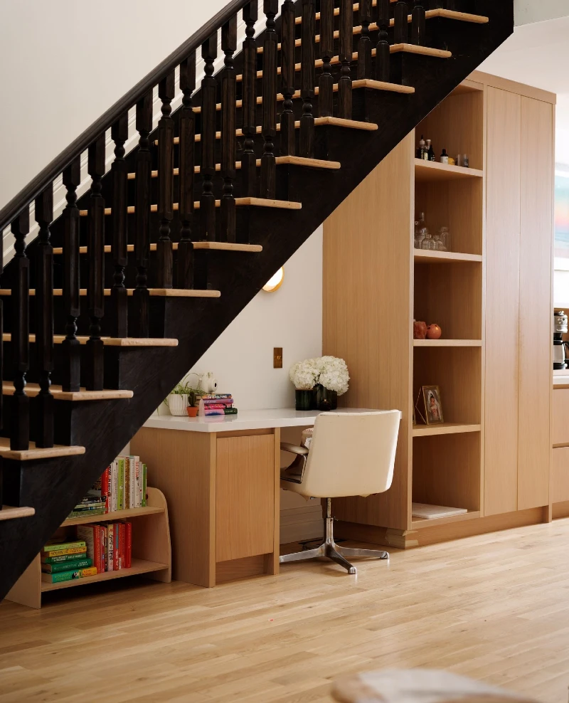 Light Oak Built-In Desk and Shelving Unit under Dark Stained Banisters
