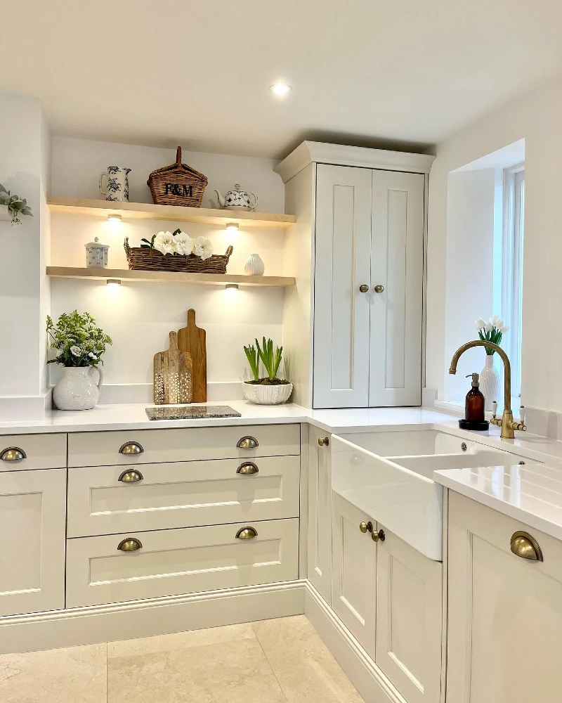 Light Timber Floating Shelves with a Lidded Picnic Hamper, Fine China, and Warm Puck Lighting