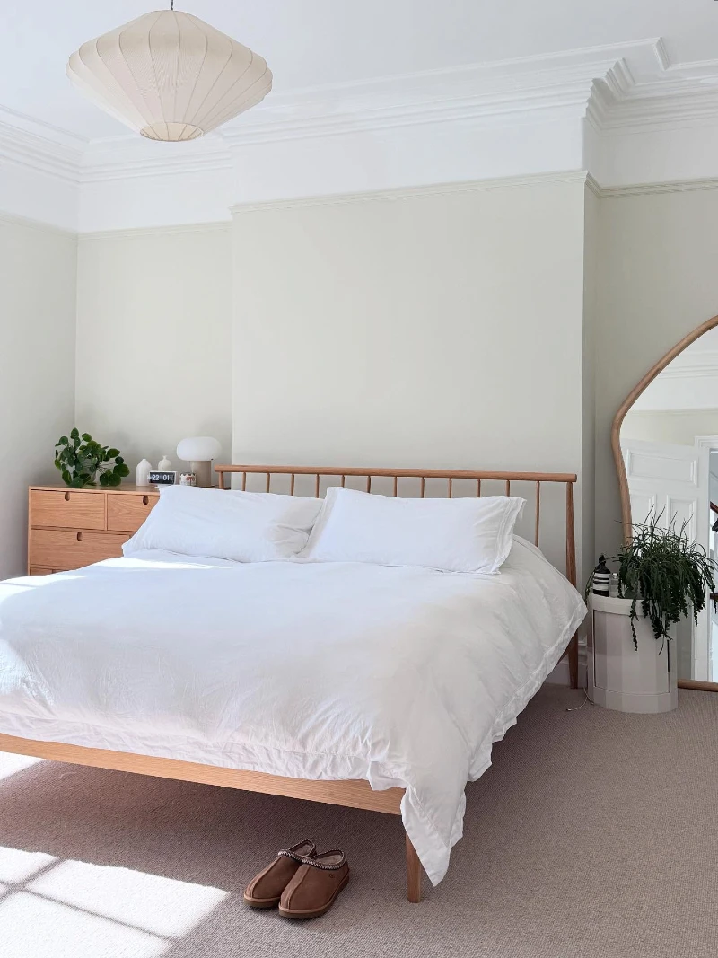 Light Wood Bed Frame with Sculptural Pendant and Airy Neutral Layers