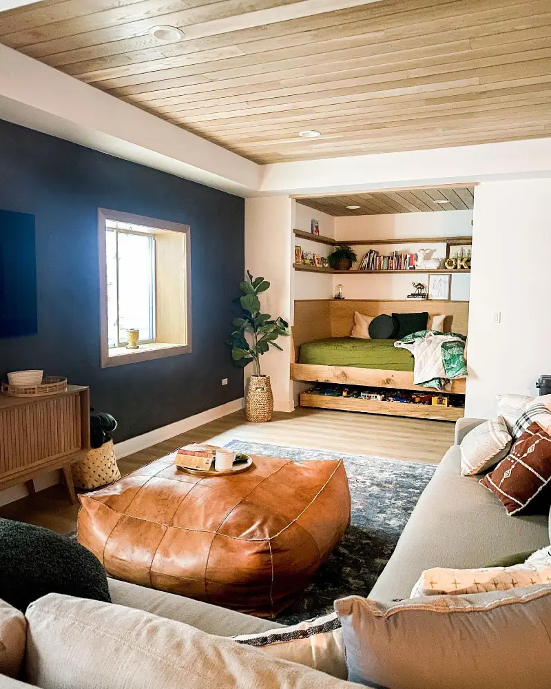 Light Wood Paneled Ceiling with Navy Blue Accent Wall and Custom Built-in Daybed Nook