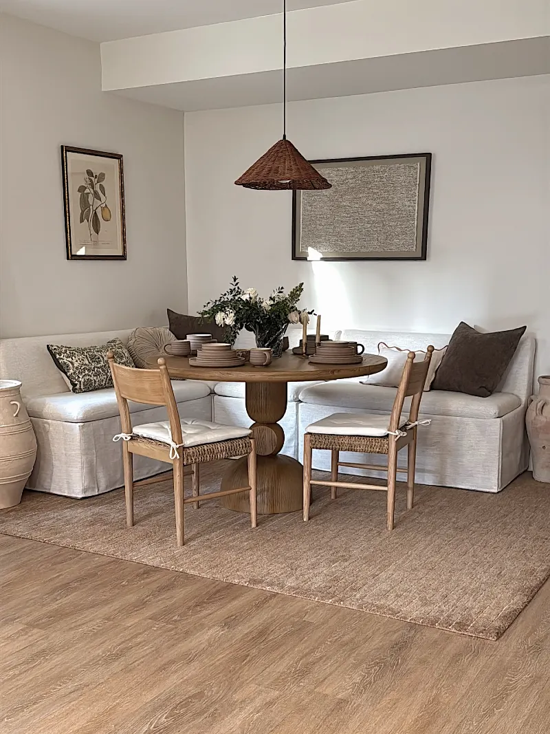 Linen Corner Banquette with Round Wood Table and Woven Cone Pendant