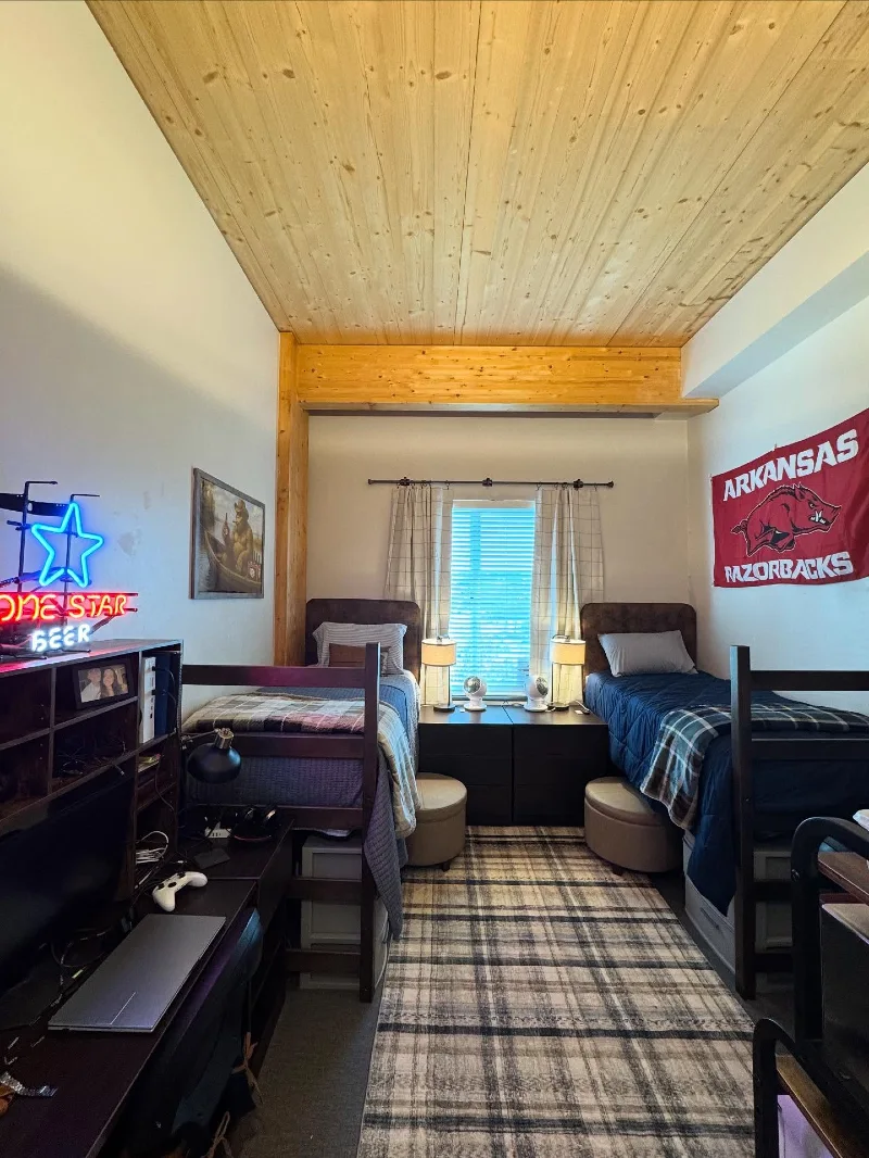 Lofted Dual Dorm Setup with Center Storage and Warm Industrial Contrast