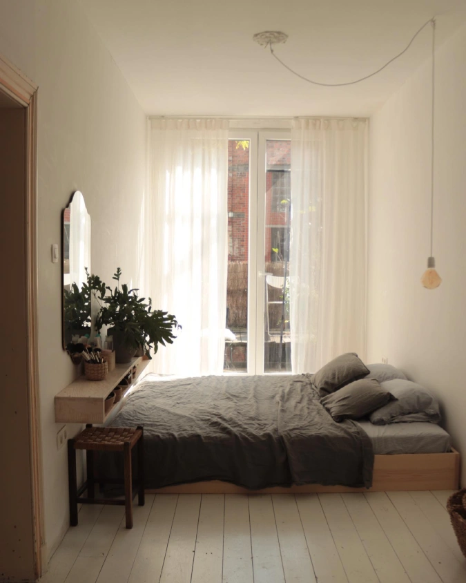 Low Wooden Platform Bed with Floating Ledge and Sheer Curtains