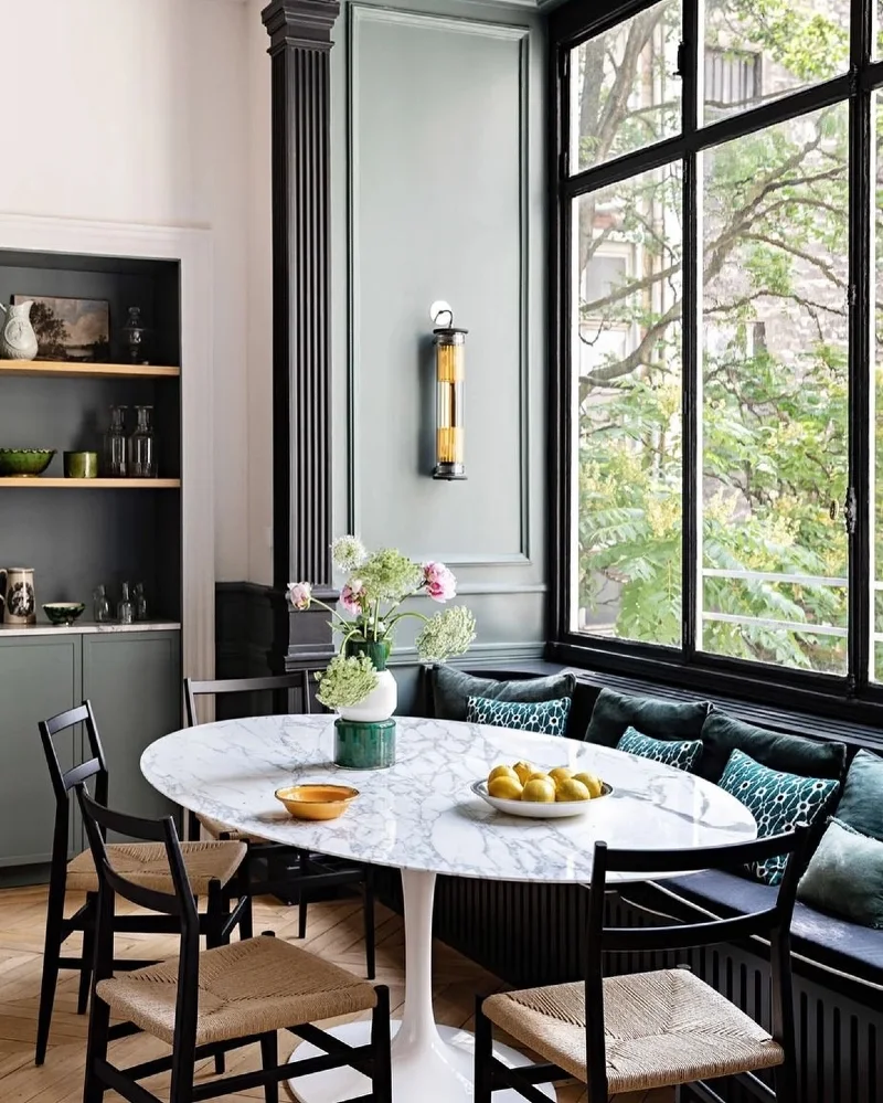 Marble Oval Table with Black Window Frames and Velvet Bench Cushions