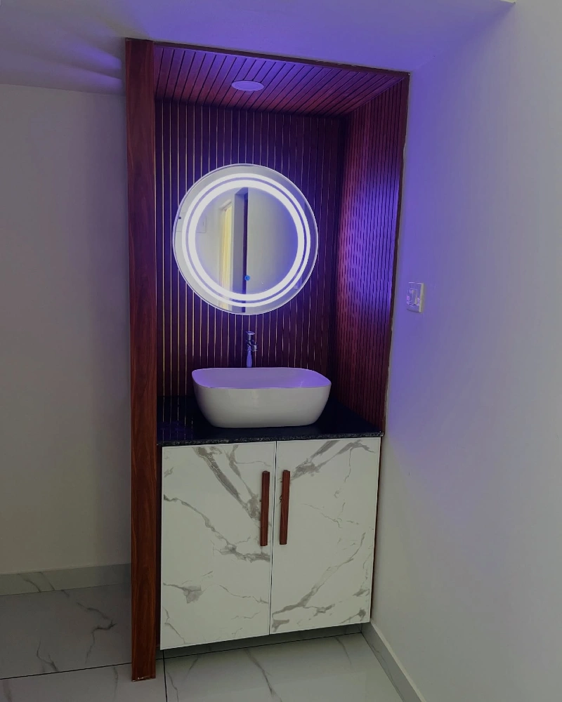 Marble Patterned Vanity with White Vessel Sink and Circular LED Backlit Mirror