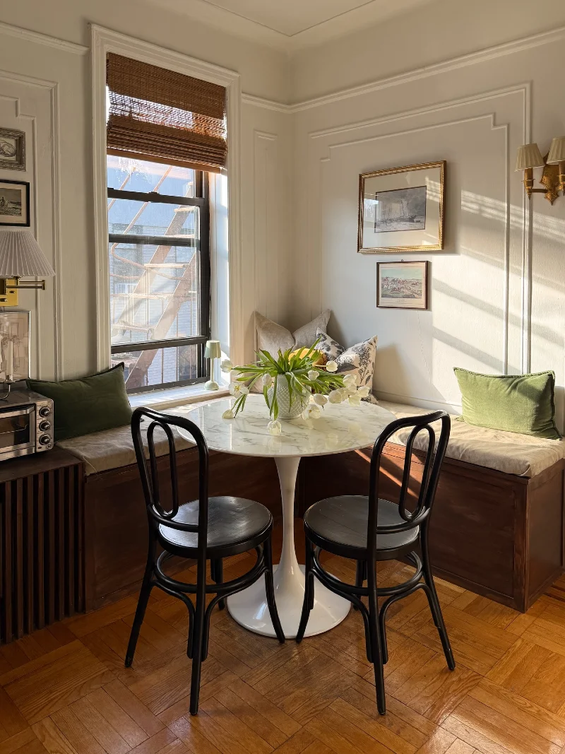 Marble Tulip Table with Wood Storage Benches and Black Bentwood Chairs