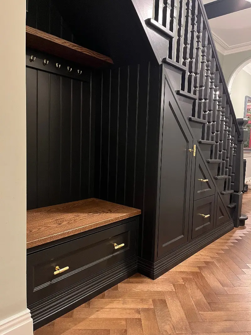 Matte Black Mudroom Nook with Oak Bench and Brass Hardware
