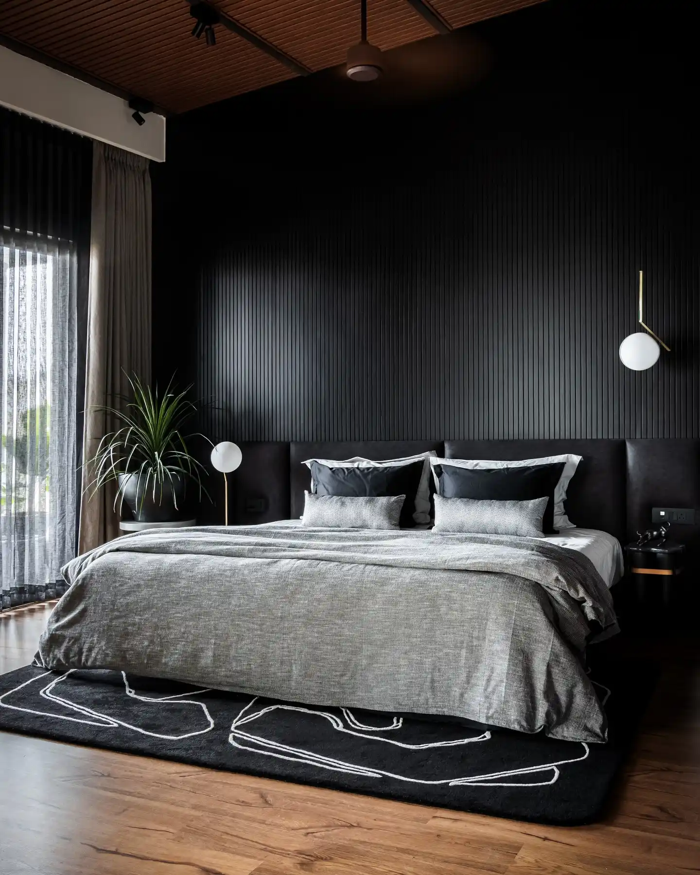Matte Black Slatted Wall Bedroom with Floating Sconces and Monochrome Layering
