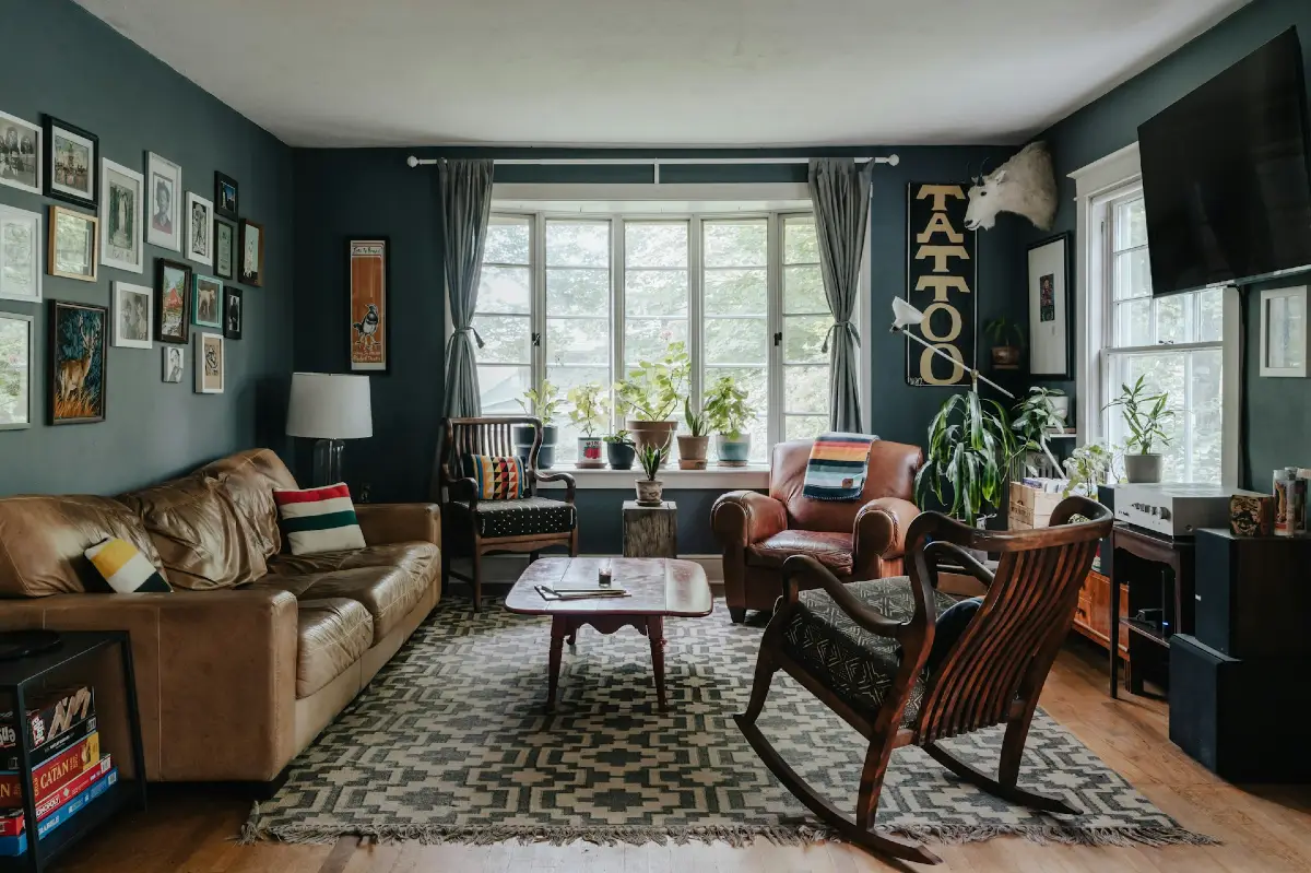 Moody Gallery Wall with Leather Seating and Bay Window Plants