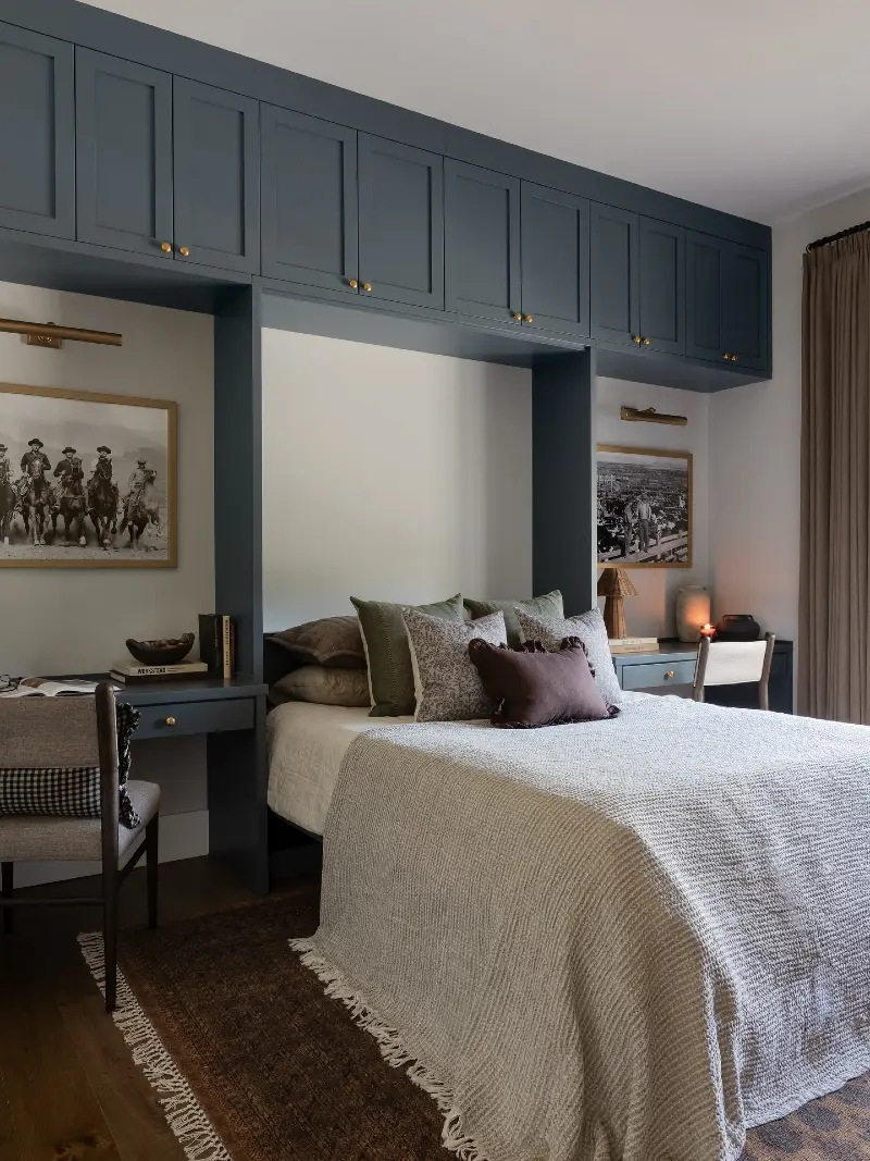 Moody Slate Blue Storage Bridge with Integrated Twin Workspaces and Ruffled Velvet Pillows