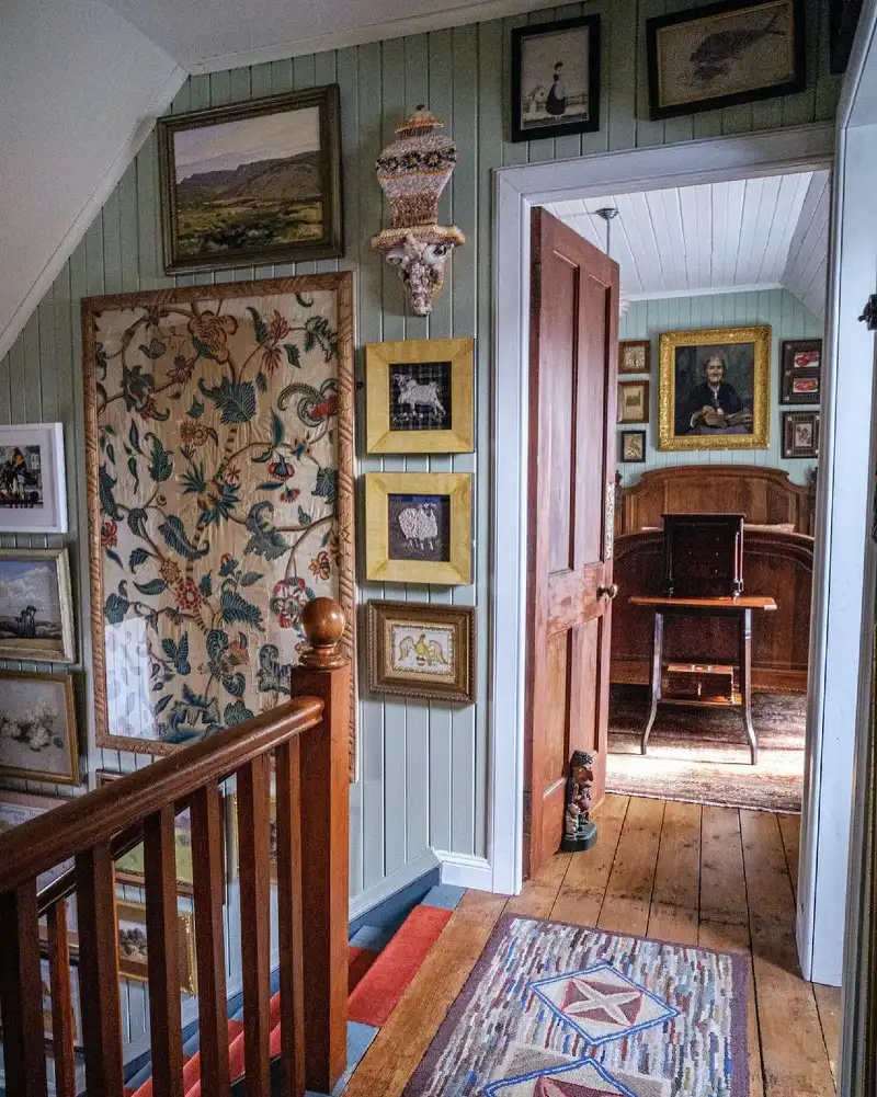 Muted Sage Shiplap Walls with an Antique Chintz Textile Frame and Folk Art Gallery