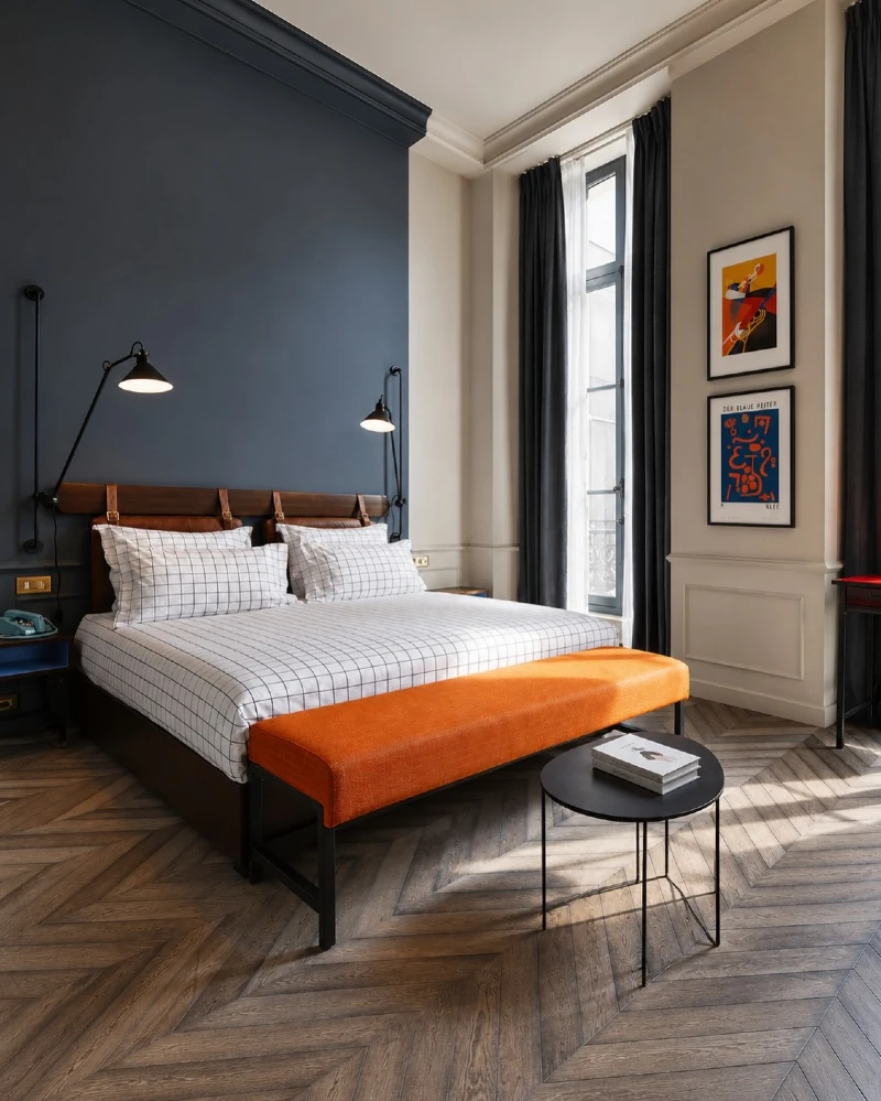 Navy Accent Wall with Grid Bedding and Bold Orange Bench Contrast